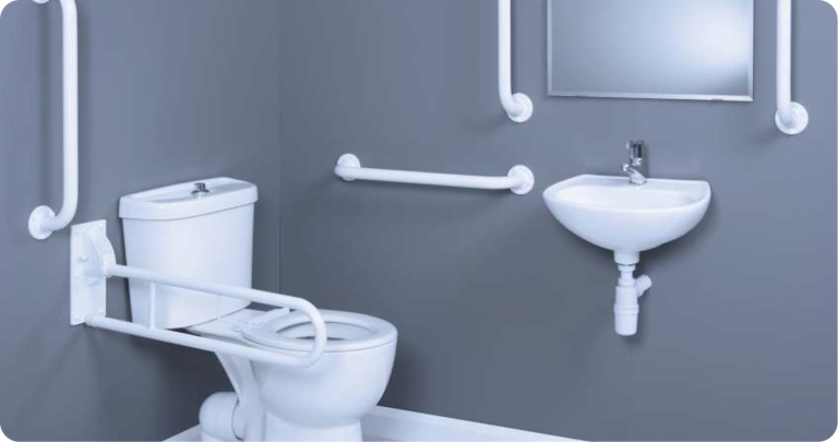 Accessible restroom setup with grab bars, wall-mounted sink, and support railings for elderly and differently-abled individuals